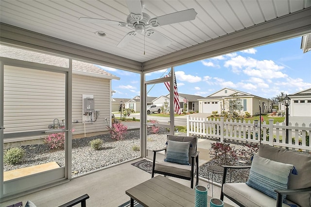 sunroom / solarium featuring ceiling fan