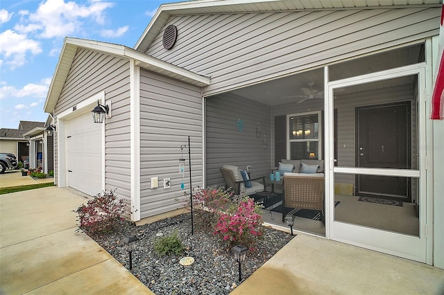 view of patio featuring ceiling fan and a garage