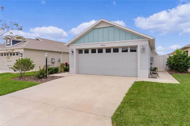 view of front facade with an attached garage, driveway, board and batten siding, and a front yard