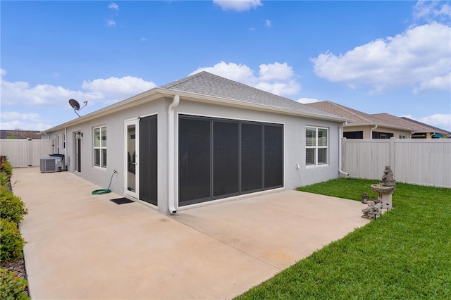 back of house with central air condition unit, stucco siding, fence, and a patio