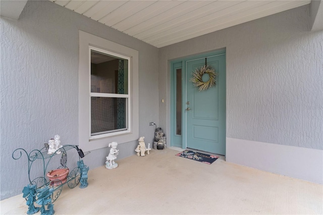 property entrance featuring stucco siding