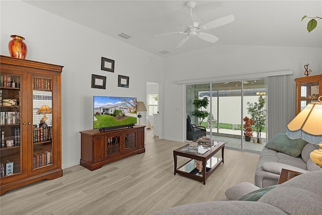 living room featuring lofted ceiling, visible vents, ceiling fan, light wood-type flooring, and baseboards