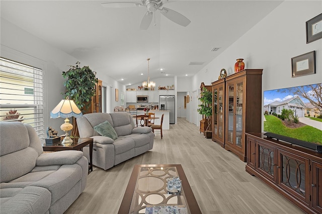 living area featuring light wood-style flooring, visible vents, vaulted ceiling, and ceiling fan with notable chandelier