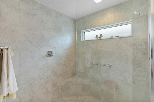 bathroom with a tile shower