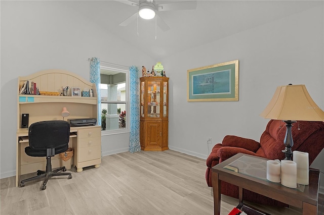 office featuring lofted ceiling, ceiling fan, light wood-type flooring, and baseboards