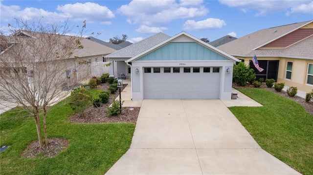 view of front facade featuring a garage, fence, driveway, a front lawn, and board and batten siding