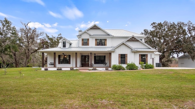 modern inspired farmhouse featuring covered porch and a front lawn