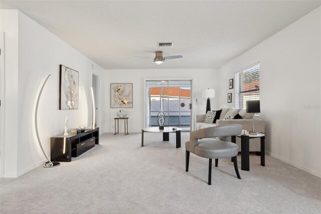 carpeted office with baseboards, ceiling fan, visible vents, and a wealth of natural light