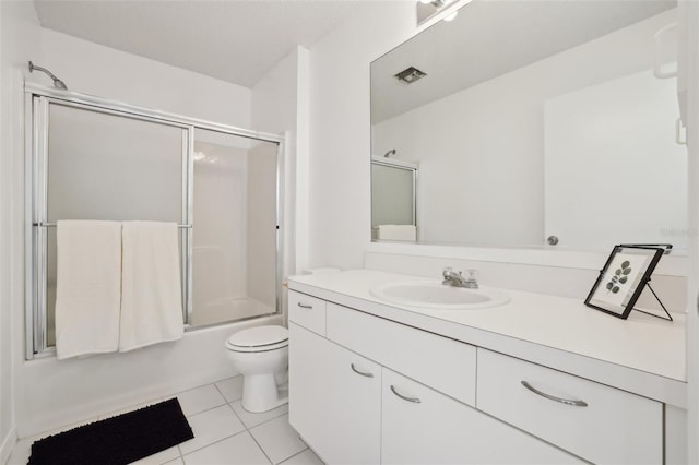 full bathroom featuring visible vents, toilet, enclosed tub / shower combo, vanity, and tile patterned floors