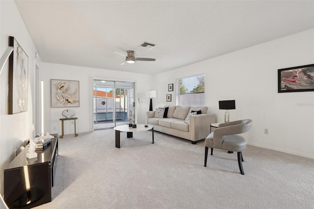 living area with light carpet, visible vents, and a healthy amount of sunlight