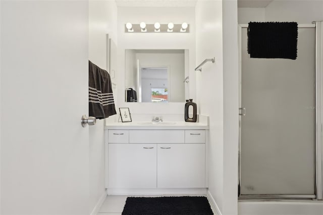 full bath with a shower stall, baseboards, and vanity