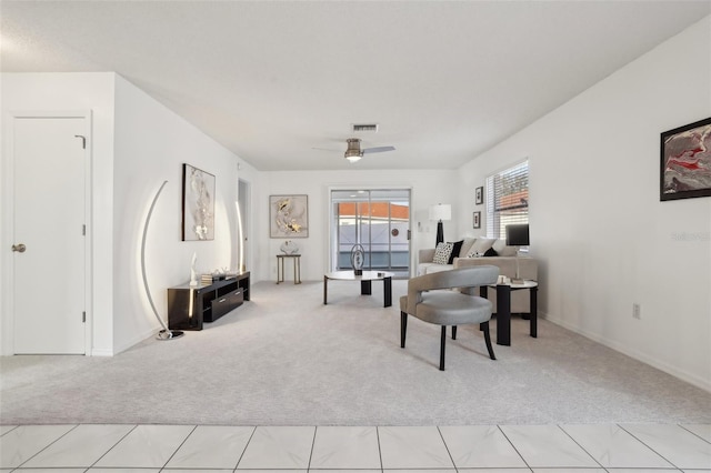 interior space featuring visible vents, light carpet, and ceiling fan