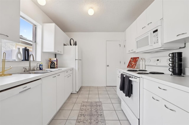 kitchen featuring a sink, a textured ceiling, white cabinetry, white appliances, and light countertops
