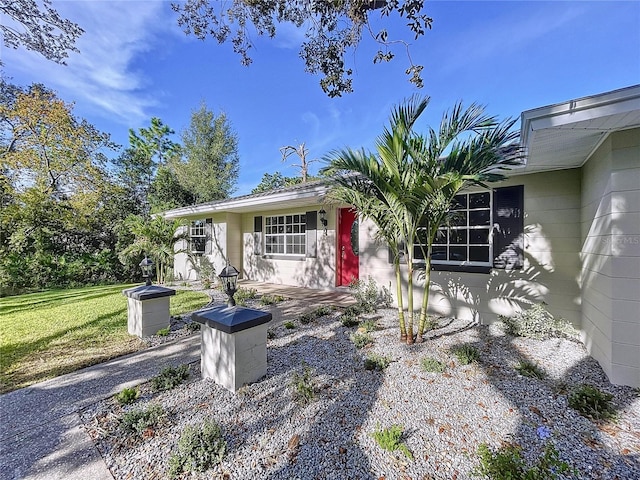 ranch-style home featuring a front yard