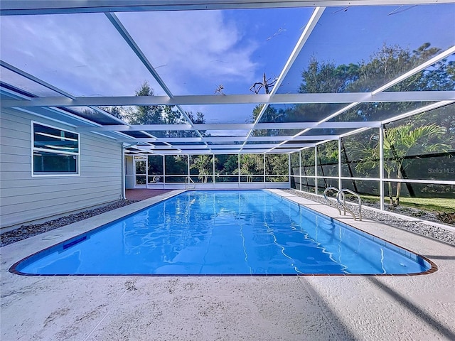 view of pool with glass enclosure