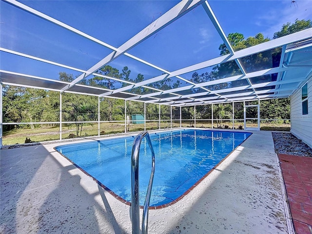 view of pool featuring a patio and glass enclosure