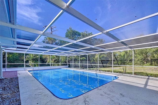 view of swimming pool with a patio and a lanai