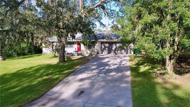 view of front facade with a garage and a front yard