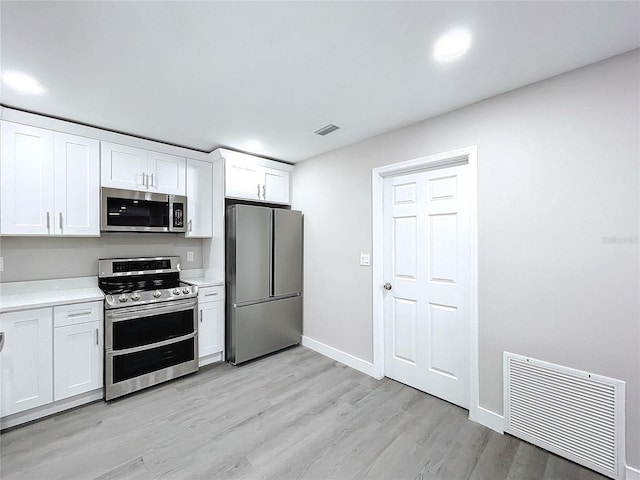 kitchen featuring white cabinetry, stainless steel appliances, and light hardwood / wood-style flooring