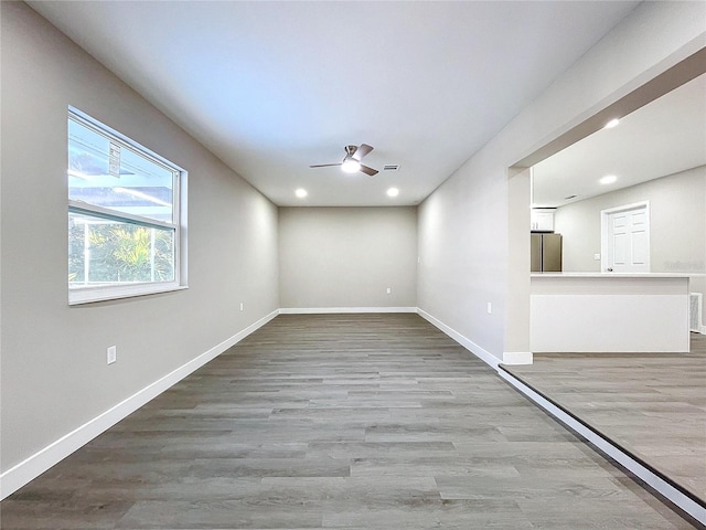 unfurnished room with ceiling fan and wood-type flooring