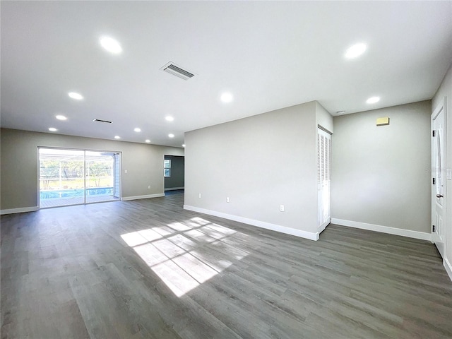 unfurnished living room featuring dark hardwood / wood-style flooring