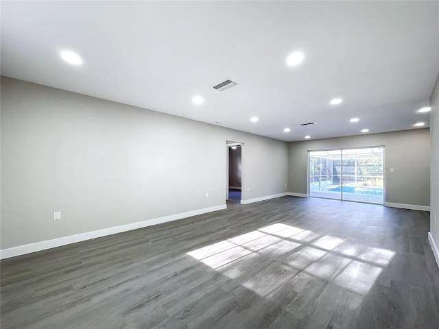 unfurnished room with dark wood-type flooring