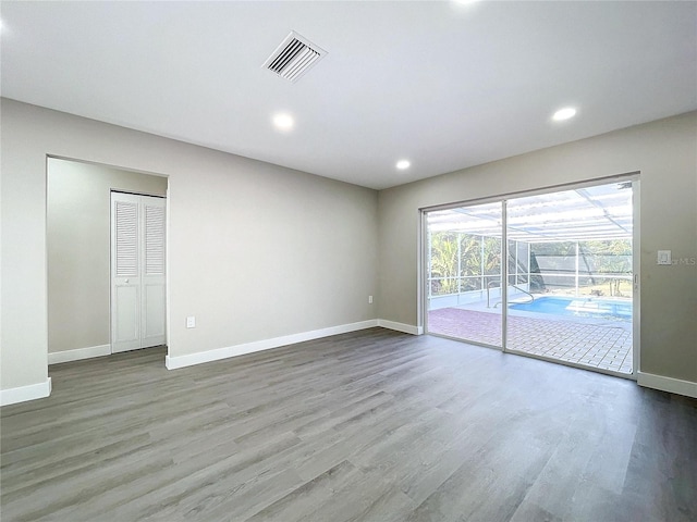 empty room with hardwood / wood-style floors