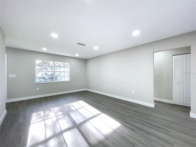 spare room featuring dark hardwood / wood-style flooring