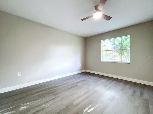 spare room featuring hardwood / wood-style flooring and ceiling fan