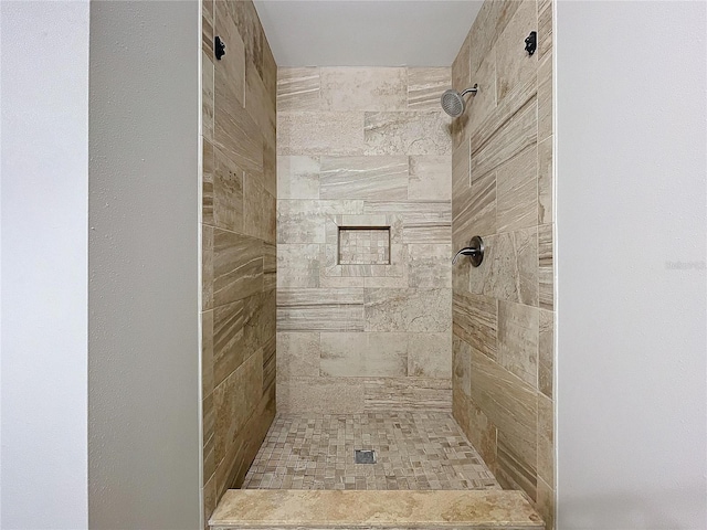 bathroom with tiled shower