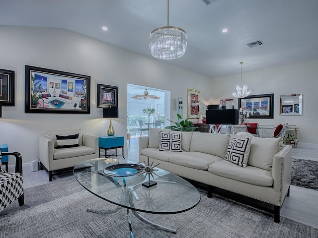 living room with visible vents, a notable chandelier, and baseboards