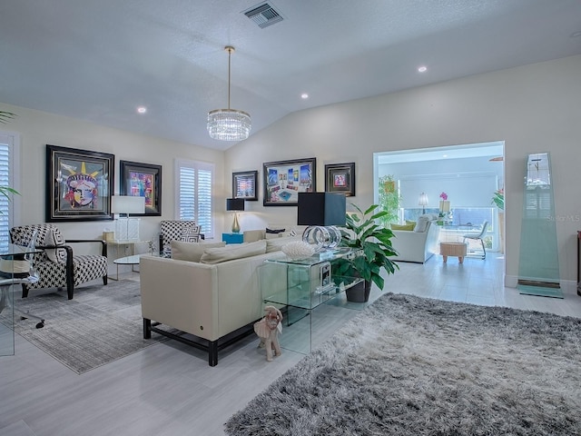 living area with vaulted ceiling, a chandelier, visible vents, and recessed lighting