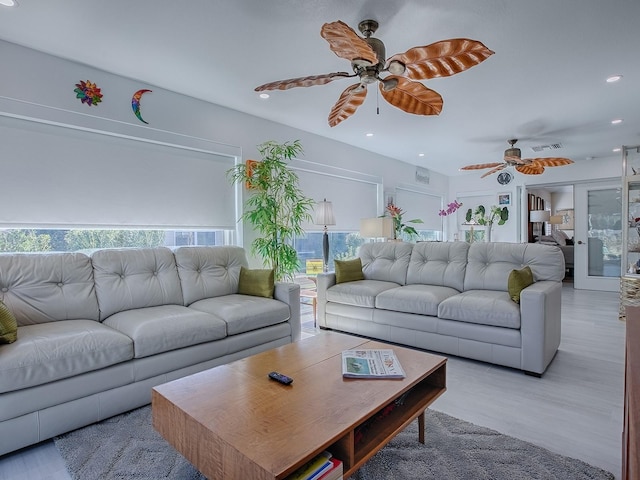 living room with a ceiling fan, light wood-type flooring, visible vents, and recessed lighting