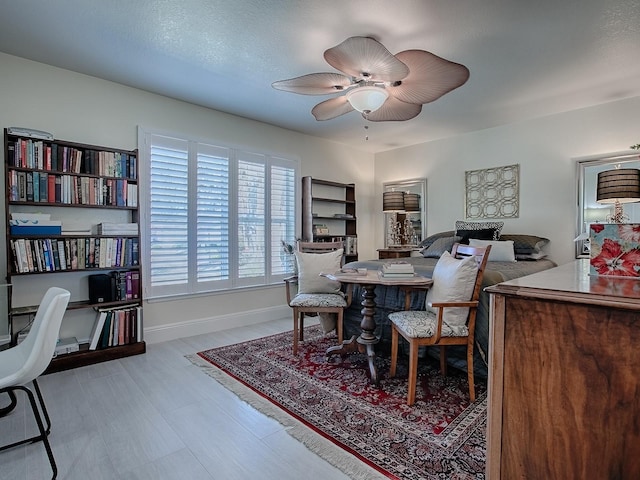 dining room featuring a ceiling fan and baseboards