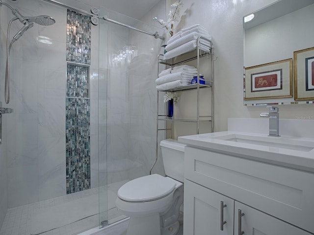 full bathroom with a stall shower, vanity, and toilet