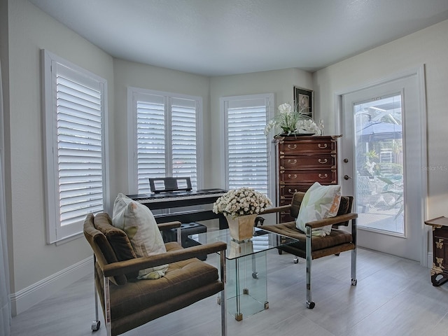 living area featuring baseboards