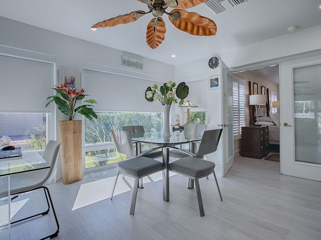 dining room featuring a healthy amount of sunlight, ceiling fan, and visible vents