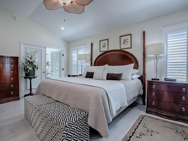 bedroom featuring lofted ceiling, ceiling fan, and light wood-style flooring