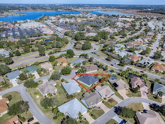 drone / aerial view with a water view and a residential view