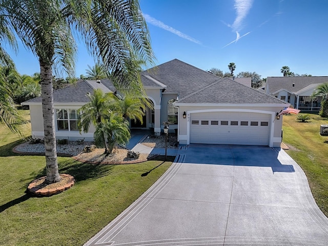 ranch-style house with an attached garage, driveway, a shingled roof, and a front yard