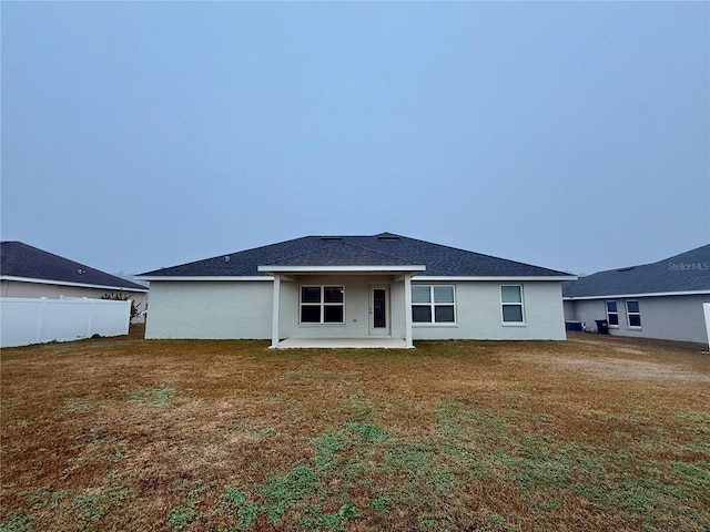 back of house featuring a yard and a patio area