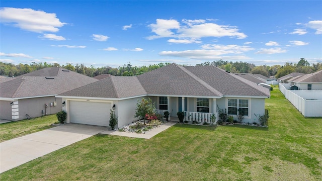 ranch-style home featuring stucco siding, covered porch, a front yard, and fence