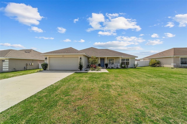 4000 SE 98th Pl, Belleview, FL 34420 - view of front of house with a front yard, fence, driveway, stucco siding, and a garage