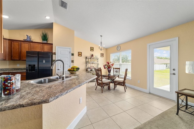 4000 SE 98th Pl, Belleview, FL 34420 - kitchen featuring visible vents, a sink, stainless steel fridge with ice dispenser, light tile patterned floors, and vaulted ceiling