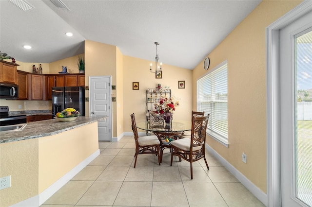 4000 SE 98th Pl, Belleview, FL 34420 - dining room with light tile patterned floors, visible vents, an inviting chandelier, and lofted ceiling