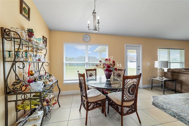 4000 SE 98th Pl, Belleview, FL 34420 - dining area featuring light tile patterned floors, baseboards, and a notable chandelier