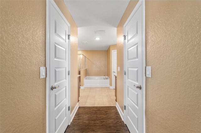 4000 SE 98th Pl, Belleview, FL 34420 - corridor featuring baseboards, dark wood finished floors, and a textured wall
