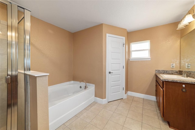 4000 SE 98th Pl, Belleview, FL 34420 - full bathroom with tile patterned flooring, baseboards, a stall shower, a bath, and vanity