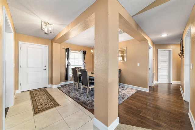4000 SE 98th Pl, Belleview, FL 34420 - tiled entrance foyer with a chandelier, visible vents, and baseboards