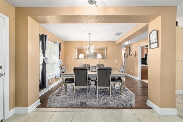 4000 SE 98th Pl, Belleview, FL 34420 - tiled dining room with visible vents, baseboards, and an inviting chandelier